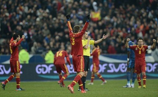 Spanish players celebrate at the end of the World Cup qualifier against France on March 26, 2013