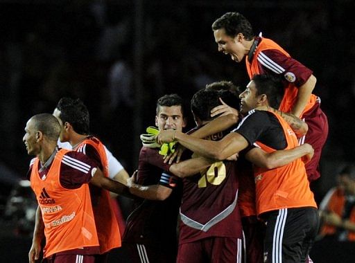 Venezuela&#039;s players celebrate defeating Colombia in a World Cup qualifier on March 26, 2013