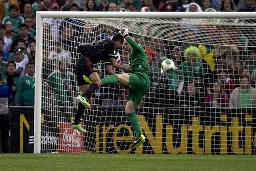 Mexico&#039;s Jesus Zavala (L) is denied by USA goalkeeper Brad Guzan during the World Cup qualifier on March 26, 2013