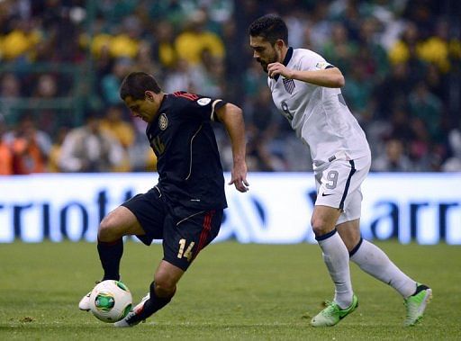 Javier Hernandez (L) pulls away from Hercules Gomez during the World Cup qualifying match on March 26, 2013