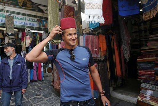 Olympic champion Oussama Mellouli visits the souk in Tunis on March 22, 2013