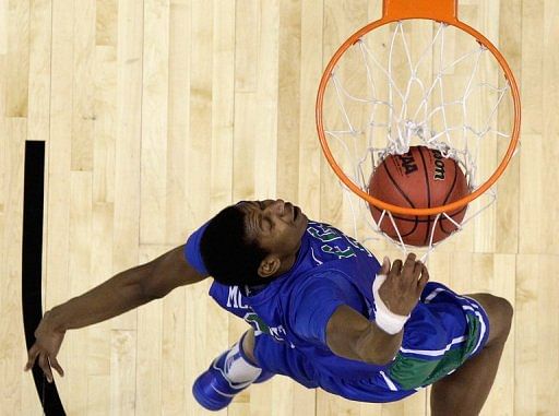Eric McKnight of the Florida Gulf Coast Eagles dunks the ball on March 24, 2013