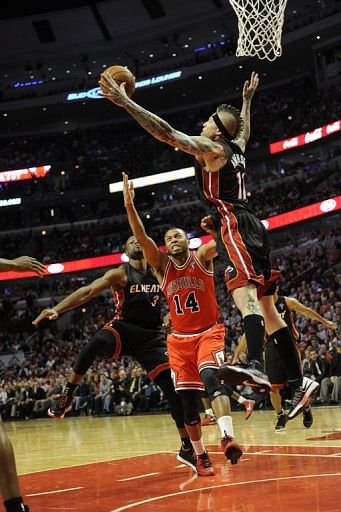 Chris Andersen (R) of the Miami Heat blocks a shot by Daequan Cook of the Chicago Bulls on March 27, 2013