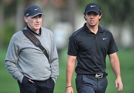 Rory McIlroy (R) talks with his coach Michael Bannon at PGA National in Palm Beach Gardens on February 27, 2013