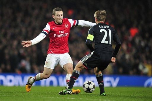 Arsenal&#039;s Jack Wilshere (L) nutmegs Bayern Munich&#039;s Philipp Lahm at the Emirates Stadium on February 19, 2013