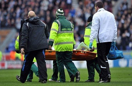 Newcastle United&#039;s defender Massadio Haidara is stretchered off the pitch in Wigan, March 17, 2013