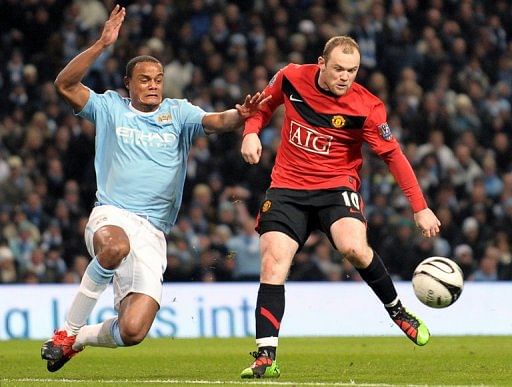 Manchester United&#039;s Wayne Rooney (right) and Manchester City&#039;s Vincent Kompany on January 19, 2010