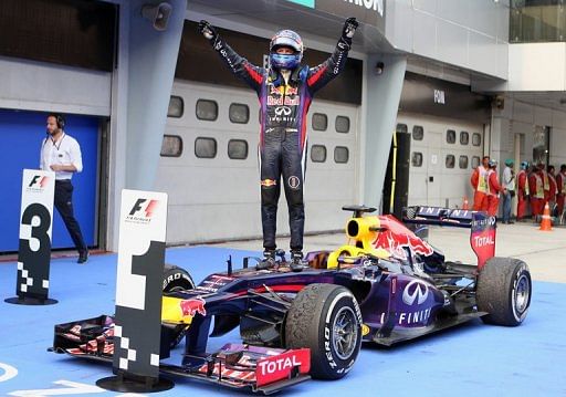 Red Bull driver Sebastian Vettel celebrates victory in the Malaysia Grand Prix in Sepang on March 24, 2013