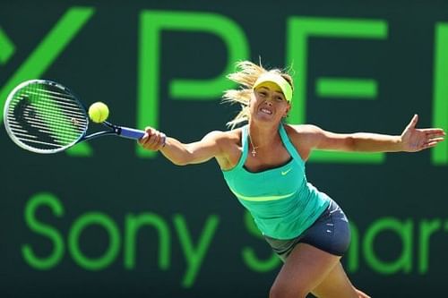 Maria Sharapova returns a shot to Serena Williams at the Miami Masters on March 30, 2013