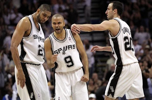 Tony Parker #9 of the San Antonio Spurs reacts with Tim Duncan #21 and Manu Ginobili #20 against the Dallas Mavericks in Game Three of the Western Conference Quarterfinals during the 2010 NBA Playoffs at AT&amp;T Center on April 23, 2010 in San Antonio, Texas. NOTE TO USER: User expressly acknowledges and agrees that, by downloading and or using this photograph, User is consenting to the terms and conditions of the Getty Images License Agreement.  (Photo by Ronald Martinez/Getty Images)