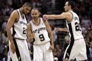 Tony Parker #9 of the San Antonio Spurs reacts with Tim Duncan #21 and Manu Ginobili #20 against the Dallas Mavericks in Game Three of the Western Conference Quarterfinals during the 2010 NBA Playoffs at AT&T Center on April 23, 2010 in San Antonio, Texas. NOTE TO USER: User expressly acknowledges and agrees that, by downloading and or using this photograph, User is consenting to the terms and conditions of the Getty Images License Agreement. (Photo by Ronald Martinez/Getty Images)