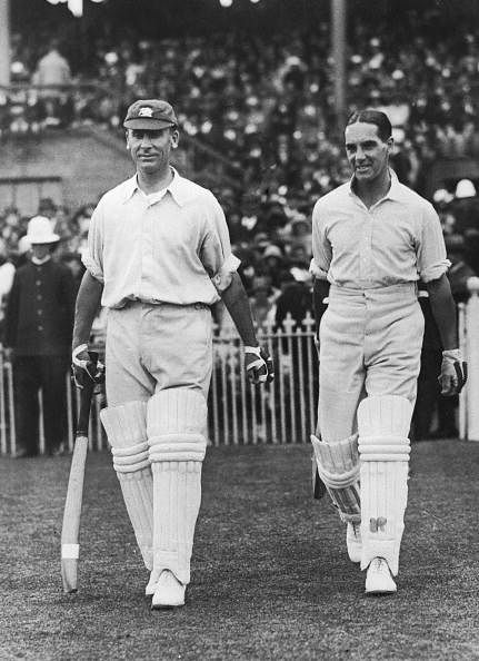 Batting partners Jack Hobbs (1882 - 1963, left) and Herbert Sutcliffe (1894 - 1978) go out to open the innings for England in the second Test at Melbourne, February 1925. The pair put on 283, their third century partnership in successive innings.