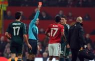 Turkish referee Cuneyt Cakir (2L) shows Manchester United's Portuguese midfielder Nani (3R) the red card to send him off during the UEFA Champions League round of 16 second leg football match between Manchester United and Real Madrid at Old Trafford