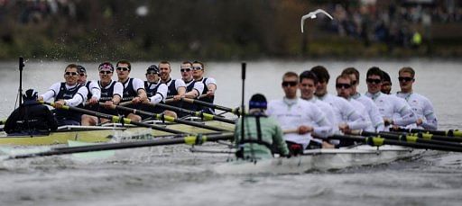 The Oxford University boat crew (L) pull ahead during the annual boat race on the River Thames in London, March 31, 2013