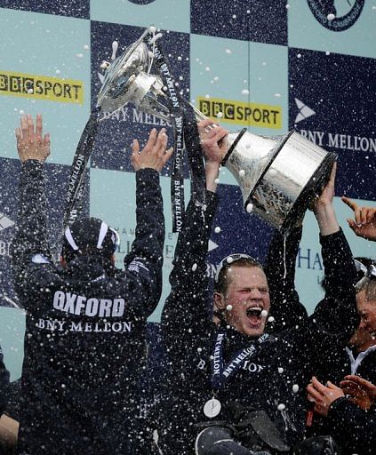 Geordie Macleod (R) of Oxford University celebrates after his team wins the annual boat race, London, March 31, 2013