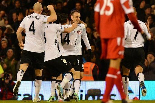 Fulham forward Dimitar Berbatov (C) celebrates his second goal during their match against QPR in London on April 1, 2013