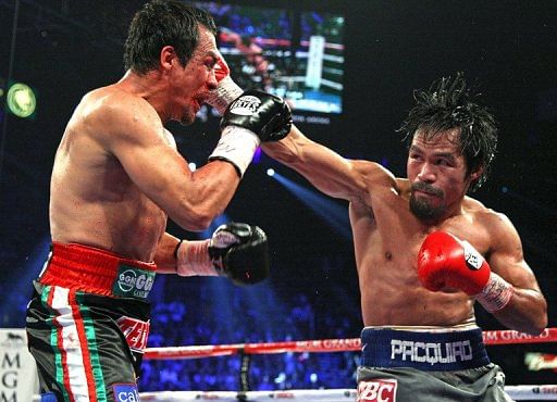 Juan Manuel Marquez (L) and Manny Pacquiao during their welterweight fight on December 8, 2012 in Las Vegas