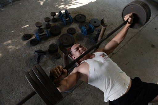 Bodybuilder Zarli Tin trains at a gym in the National Stadium compound in Yangon on February 15, 2013