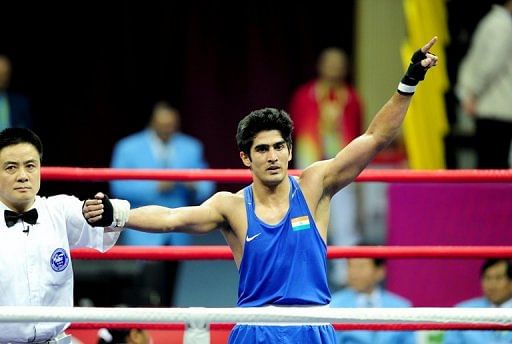 Vijender Singh salutes after victory at the Asian Games on November 26, 2010