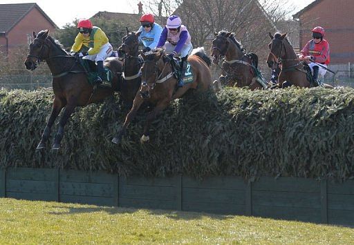 Battlefront ridden by Katy Walsh (L) during the Fox Hunters Steeple Chase on April 4, 2013