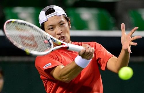 Tatsuma Ito of Japan returns a shot against Jeong Suk-Young of South Korea in Tokyo on April 5, 2013