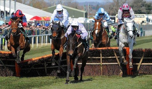 Solwhit ridden by Paul Carberry (third-right) clears the last fence at the Grand National in Liverpool on April 6, 2013