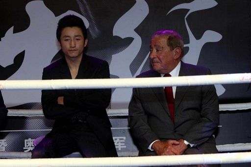 Chinese boxer Zou Shiming (L) is pictured after signing with US promoter Bob Arum, in Beijing, on January 23, 2013
