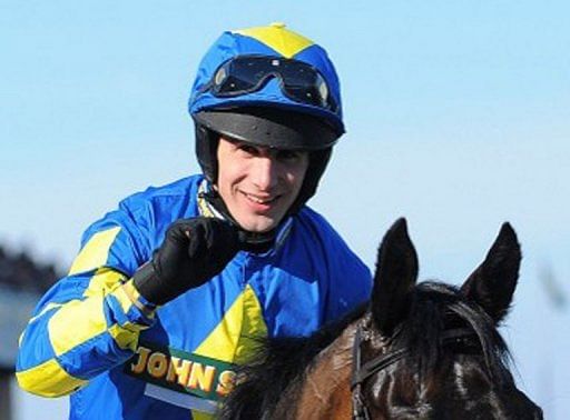 Ryan Mania on Auroras Encore celebrates after winning the Grand National horse race at Aintree on April 6, 2013