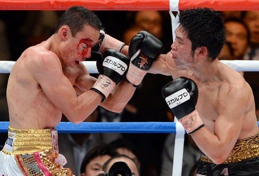 Takashi Miura (right) and Gamaliel Diaz of Mexico exchange punches in Tokyo on April 8, 2013