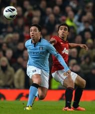United's Rafael Da Silva (R) vies with City's Samir Nasri (L) at Old Trafford in Manchester, on April 8, 2013