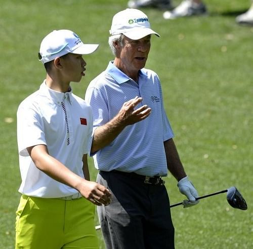 Guan Tianlang and Ben Crenshaw are pictured during a practice round ahead of the Masters tournament on April 8, 2013