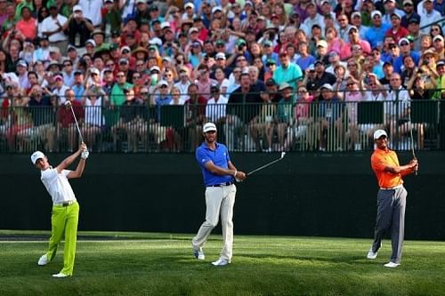 (L-R) Guan Tianlang, Dustin Johnson and Tiger Woods during a practice round in Augusta, Georgia on April 8, 2013