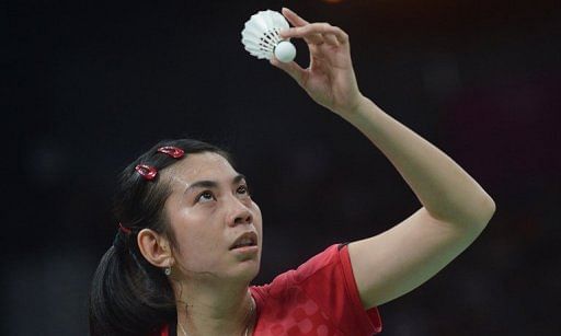 Indonesia&#039;s Adrianti Firdasari eyes the shuttlecock before serving at the Olympic Games in London on July 30, 2012