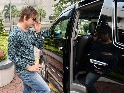 Businessman Eric Ding, 31, gets in a car outside Singapore's Subordinate courts on April 9, 2013