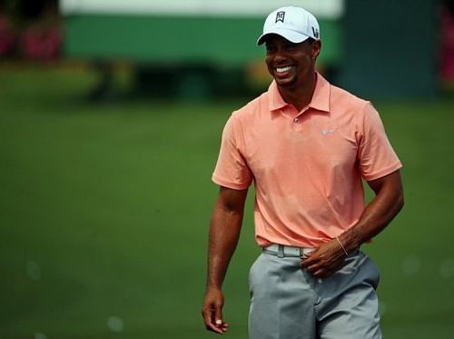 Tiger Woods of the United States smiles after hitting on the practice range on April 9, 2013 in Augusta