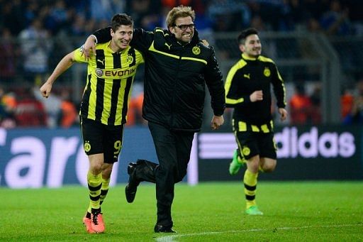 Dortmund coach Juergen Klopp celebrates with striker Robert Lewandowski (L) after they defeat Malaga on April 9, 2013