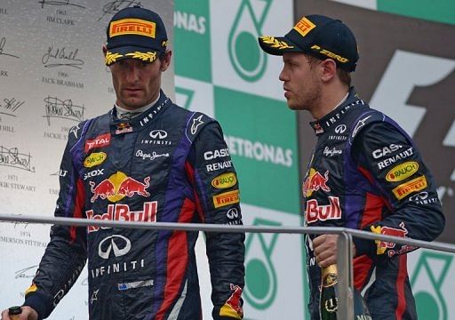 Sebastian Vettel (R) walks off the podium with his teammate Mark Webber at the Malaysian Grand Prix on March 24, 2013