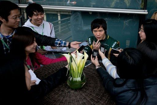 Chinese driver Ma Qinghua (C) speaks to reporters during a practice session in Shanghai on April 12, 2013