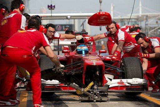 Ferrari driver Fernando Alonso enters the pits during a practice session in Shanghai, on April 12, 2013