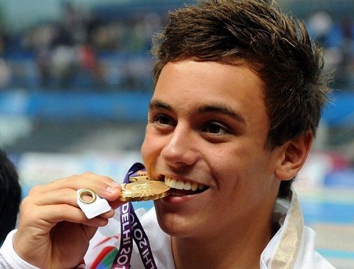 Tom Daley poses after winning the gold in the men&#039;s 10m platform diving finals in New Delhi on October 13, 2010