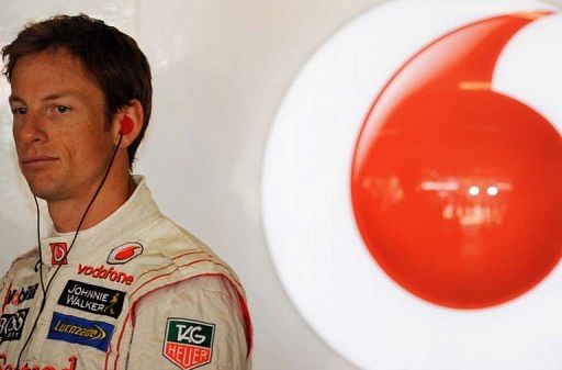 Jenson Button looks out of the garage during the practice session of F1 Chinese Grand Prix in Shanghai on April 12, 2013