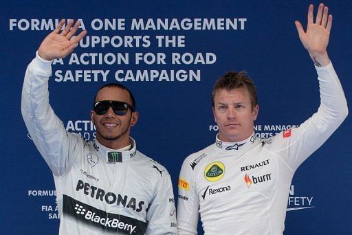 Lewis Hamilton (left) and Kimi Raikkonen wave following their qualifying session in Shanghai, on April 13, 2013