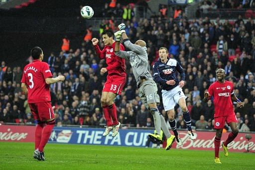 Wigan Athletic&#039;s goalkeeper Ali Al Habsi (3rd L) punches the ball clear at Wembley Stadium, April 13, 2013