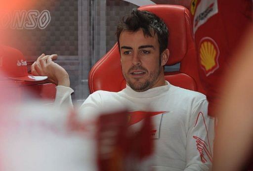 Ferrari driver Fernando Alonso relaxes before F1 Chinese Grand Prix practice session in Shanghai on April 13, 2013