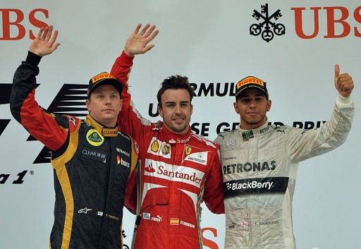 Fernando Alonso (centre) on the podium with Kimi Raikkonen (left) and Lewis Hamilton in Shanghai, April 14, 2013