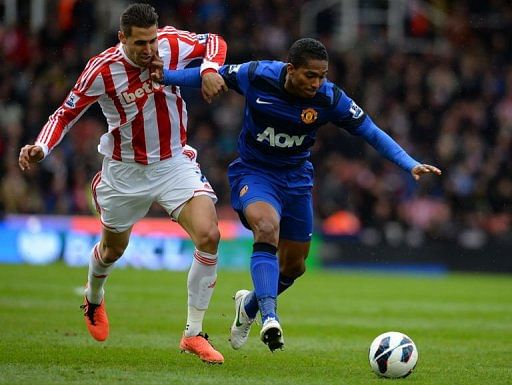 United&#039;s Antonio Valencia (right) vies with Geoff Cameron in Stoke-on-Trent on April 14, 2013