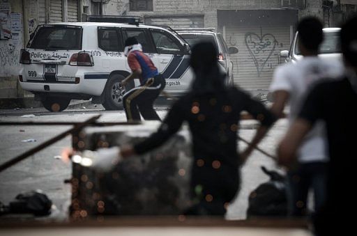 Bahraini protestors clash with riot police following an anti-regime protest in the village of Sanabis, on April 13, 2013