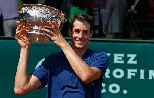 John Isner celebrates with the trophy on April 14, 2013 in Houston