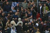 Millwall fans fight in the crowd during the match between Millwall and Wigan Athletic at Wembley Stadium, April 13, 2013