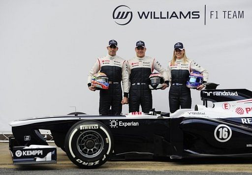 Susie Wolff with Williams drivers Pastor Maldonado (left) and Valtteri Bottas in Barcelona on February 19, 2013